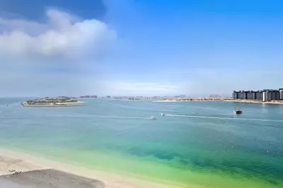 a view of a beach with boats in the water at Grand Bleu by Elie Saab Residency, Private Beach - Dubai Harbour - 2BR in Dubai