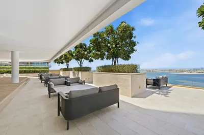 a patio with couches and a view of the water at Grand Bleu by Elie Saab Residency, Private Beach - Dubai Harbour - 2BR in Dubai