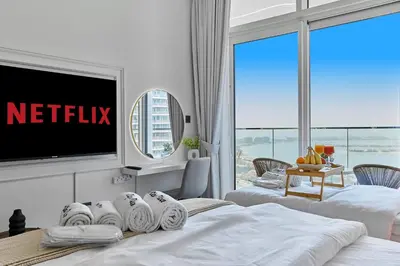 a hotel room with two beds and a tv at PS5- Designer 2BR with Private Beach, Dubai Eye, Palm in Dubai