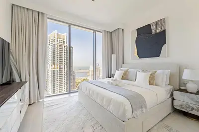 a white bedroom with a large bed and a large window at Oshima LIV Marina 1BR Marina View in Dubai