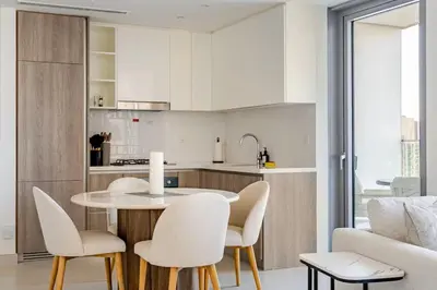 a kitchen with a table and chairs in a room at Oshima LIV Marina 1BR Marina View in Dubai