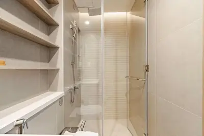 a bathroom with a shower with a glass door at Oshima LIV Marina 1BR Marina View in Dubai