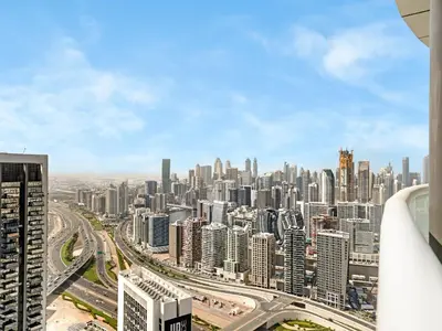 an aerial view of a large city with tall buildings at Sky-high 1Br Apartment Sleeps 4 in Damac Paramount in Dubai