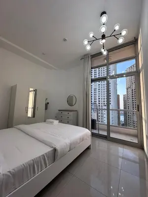 a bedroom with a large bed and a large window at Marina Beach JBR 1BR Apartment in Dubai Marina in Dubai