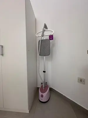 a pink vacuum in a corner of a room at Marina Beach JBR 1BR Apartment in Dubai Marina in Dubai