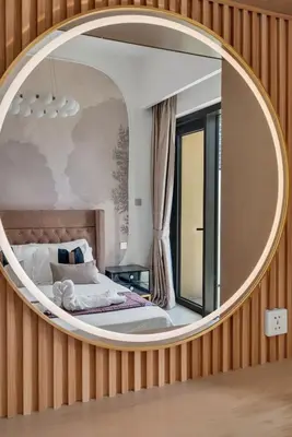 a bedroom with a large circular mirror on the wall at Downtown Suite Trendy 1BR -Dubai Mall Access in Dubai