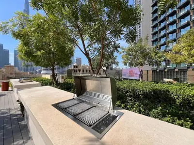 a laptop computer sitting on a bench in a city at Downtown Suite Trendy 1BR -Dubai Mall Access in Dubai