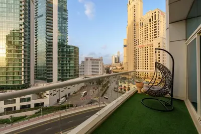 a balcony with a bench and a view of a city at Coastal Elegance with PlayRoom PS5, 4BHK front JBR Beach Sleep 14 pax in Dubai