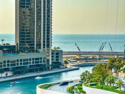 a view of a city with buildings and the ocean at Coastal Elegance with PlayRoom PS5, 4BHK front JBR Beach Sleep 14 pax in Dubai