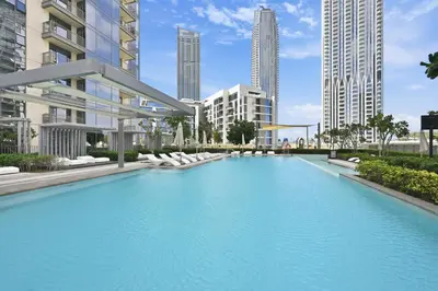 a large swimming pool in a city with tall buildings at Creek Rise Tower 2 - 1BR with Creek Views, Panoramic Living, Dubai Creek Harbour in Dubai