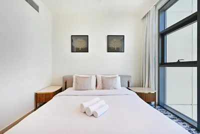 a bedroom with a bed with two towels on it at Creek Rise Tower 2 - 1BR with Creek Views, Panoramic Living, Dubai Creek Harbour in Dubai