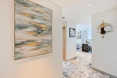 a living room with a large painting on the wall at Creek Rise Tower 2 - 1BR with Creek Views, Panoramic Living, Dubai Creek Harbour in Dubai