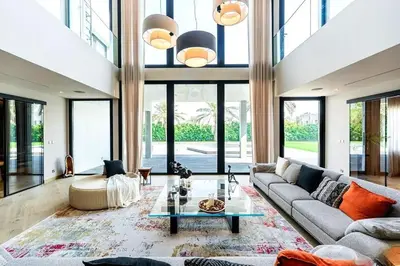 a living room with a couch and a table at Luxurious 4 Bedroom Villa In Emirates Hills in Dubai