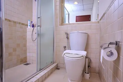 a bathroom with a shower and a toilet with a glass door at JBR 2BR with Iconic Palm Views Sadaf 6 Luxury in Dubai