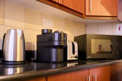 a kitchen with a coffee maker and a microwave at JBR 2BR with Iconic Palm Views Sadaf 6 Luxury in Dubai