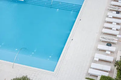 a swimming pool on the side of a building at Seaside Stay at Beach Mansion with Private Beach in Dubai