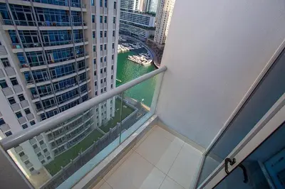 a balcony with a view of a river and buildings at 2 Bedroom Apartment JBR Skyline with Balcony in Dubai