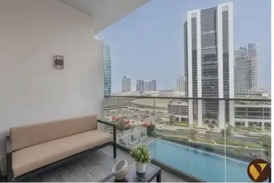 a living room with a couch and a large window at Vogue Downtown Mag 318 near Burj Khalifa and Dubai Mall, Studio Apartment with Balcony, Pool and City View, Access to all Amenities in Dubai