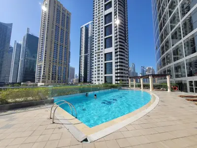 a swimming pool in a city with tall buildings at One Bedroom Apartment in Mag 214, JLT in Dubai