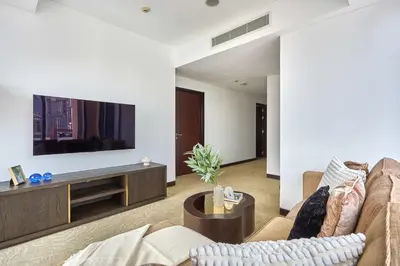 a living room with a couch and a tv at Frank Porter - Dubai Marina Mall Hotel in Dubai