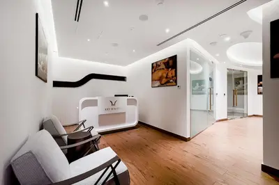 a living room with white furniture and a staircase at Luxury 1BR Duplex on the Canal Business Bay in Dubai