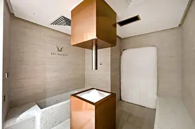 a lobby of a building with a chandelier at Luxury 1BR Duplex on the Canal Business Bay in Dubai