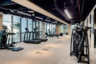 a gym with treadmills and ellipticals in a building at Luxury 1BR Duplex on the Canal Business Bay in Dubai