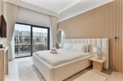 a bedroom with a bed with a teddy bear on it at Spacious 4 Bed Villa with Private Pool and Meydan in Dubai