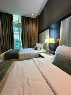 a hotel room with two beds and a window at Damac Upper Crest 2BR Dubai Mall Near 5 min walk in Dubai