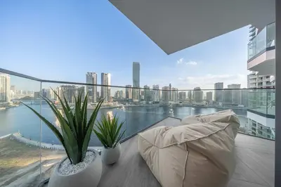 a living room with a balcony with a view of the city at Stayshort - 1 Bedroom in Business Bay with Canal Views that Sleeps 4 in Dubai