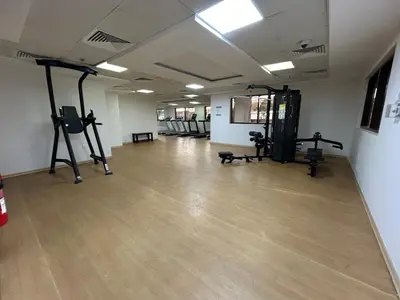 a gym with several tread machines in a room at Mavies Estate Al Jaddaf by Marriot in Dubai