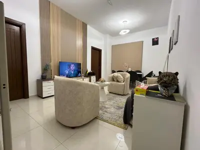 a living room with a cat sitting on a counter at Mavies Estate Al Jaddaf by Marriot in Dubai