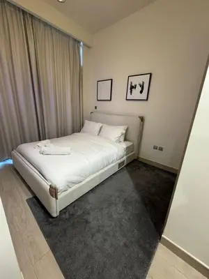 a bedroom with a white bed in a room at Iconic Studio in Azizi 48 with Pool and Gym in Dubai