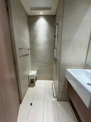 a bathroom with a shower and a sink and a toilet at Iconic Studio in Azizi 48 with Pool and Gym in Dubai