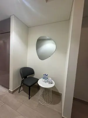 a black chair and a table in a room at Iconic Studio in Azizi 48 with Pool and Gym in Dubai