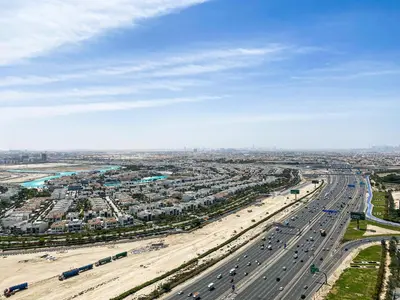 an overhead view of a highway with traffic and a beach at Blissful Escape 2 BDR In Bayz-19 in Dubai