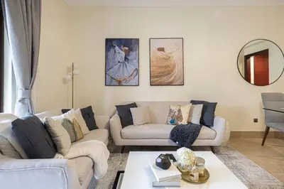 a living room with two couches and a table at Dubai Icon Suite at Miska 2 in Dubai