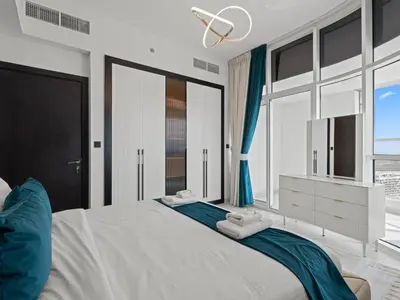 a bedroom with a large bed with blue curtains at Opalz Grandeur Escape 2BDR w Mini Pool-06 in Dubai