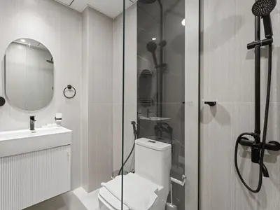a bathroom with a toilet and a sink and a shower at Opalz Grandeur Escape 2BDR w Mini Pool-06 in Dubai