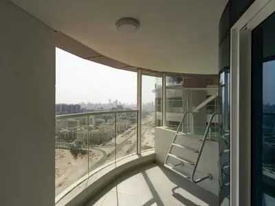 a balcony in a building with a view of a city at Opalz Grandeur Escape 2BDR w Mini Pool-06 in Dubai