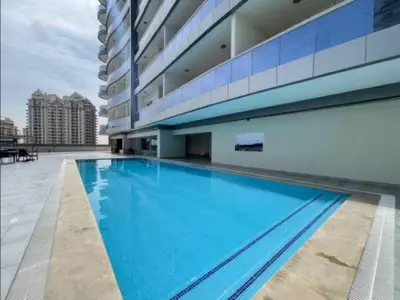 a large swimming pool in the middle of a building at Vogue Sports City Hera Tower Near First Avenue Mall, Studio Apartment with Balcony, Canal and City View, Access to all Amenities in Dubai