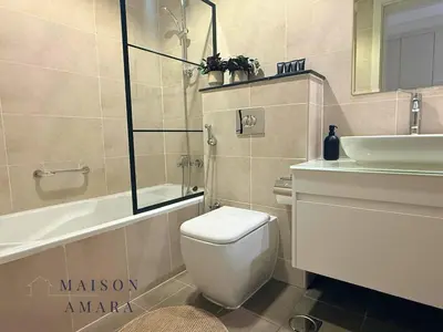 a bathroom with a toilet and a sink at Modern Luxury Studio Damac Hills With Golf View in Dubai