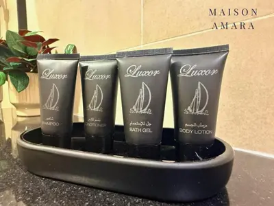a group of four products in a container on a counter at Modern Luxury Studio Damac Hills With Golf View in Dubai