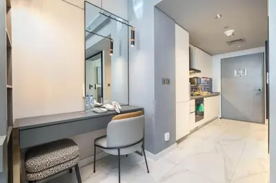 a bathroom with a desk with a chair and a mirror at Vogue Downtown Mag 318 near Burj Khalifa and Dubai Mall, Studio Apartment with Balcony and City View, Access to all Amenities in Dubai