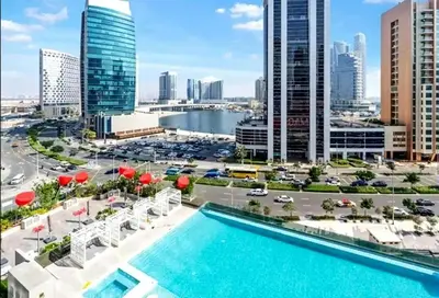a view of a city skyline with a pool at Vogue Downtown Mag 318 near Burj Khalifa and Dubai Mall, Studio Apartment with Balcony and City View, Access to all Amenities in Dubai