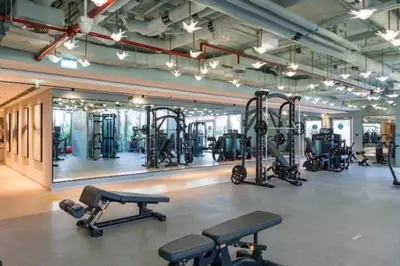 a gym with several treadmills and other exercise equipment at Vogue Downtown Mag 318 near Burj Khalifa and Dubai Mall, Studio Apartment with Balcony and City View, Access to all Amenities in Dubai