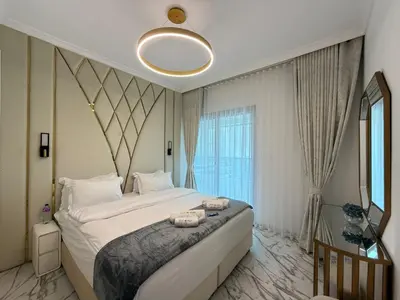 a bedroom with a large bed and a large window at Luxury 1BDR in the heart of Marina Walk to Metro & Promenade #11 in Dubai