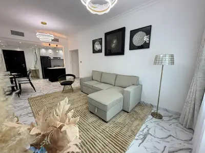a living room with a couch and a table at Luxury 1BDR in the heart of Marina Walk to Metro & Promenade #11 in Dubai