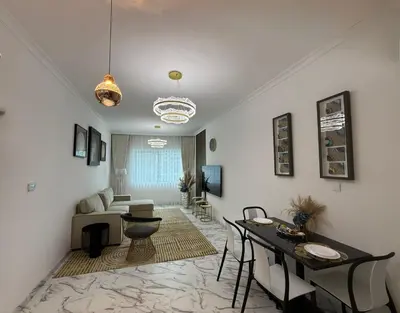 a living room with a table and a dining room at Luxury 1BDR in the heart of Marina Walk to Metro & Promenade #11 in Dubai