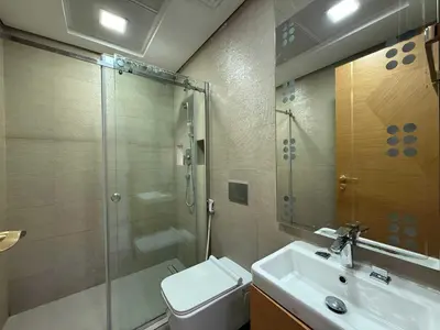 a bathroom with a shower and a toilet and a sink at Chic Studio in Dar Al Jawhara Residence in Dubai